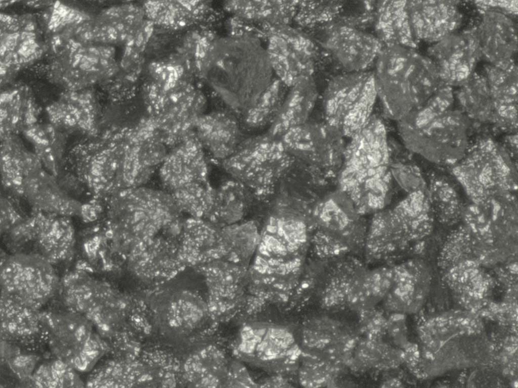 Coating of irregular particles under microscope